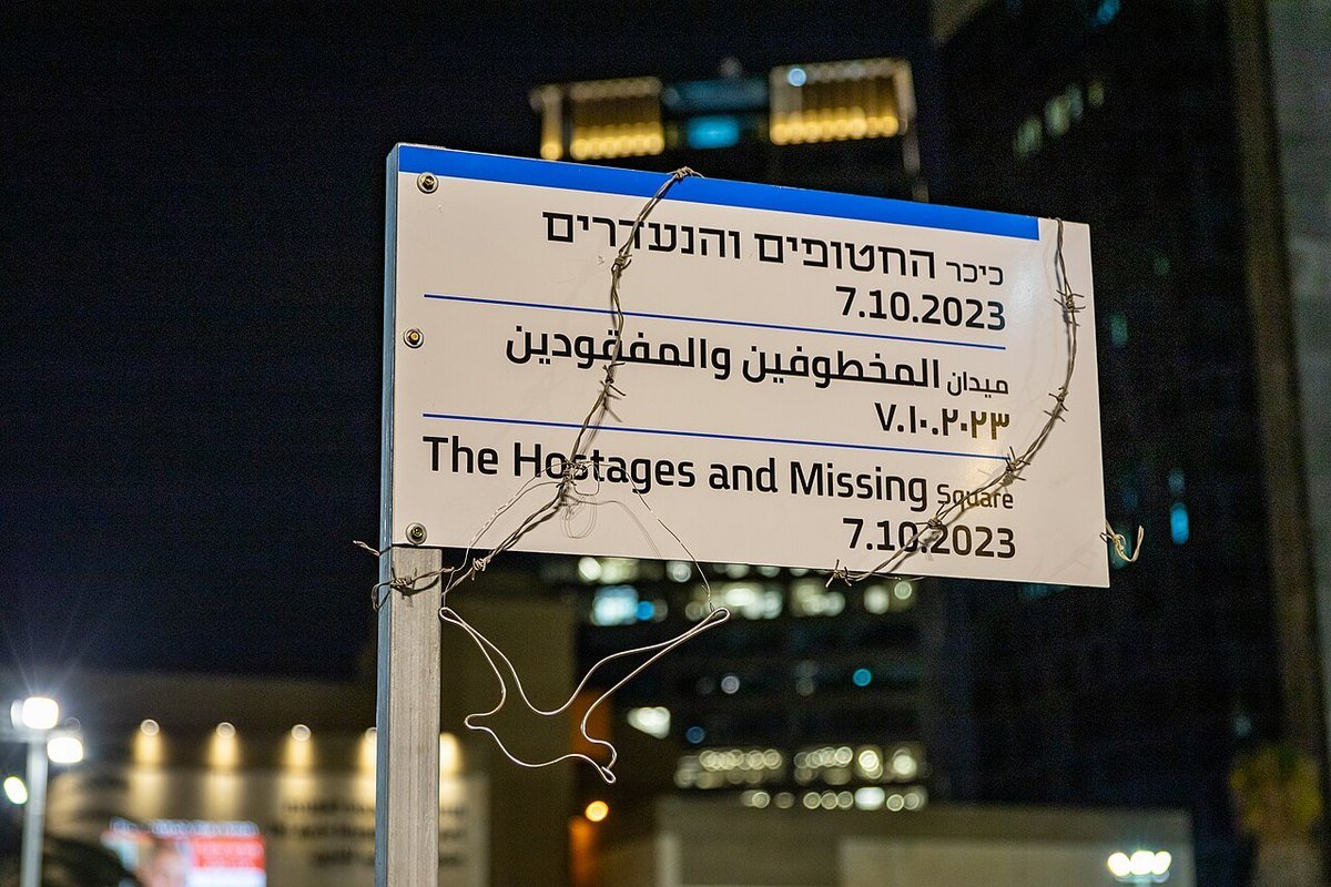 Street sign reading The Hostages and Missing Square 7.10.2023 in Hebrew, Arabic and English, Tel Aviv